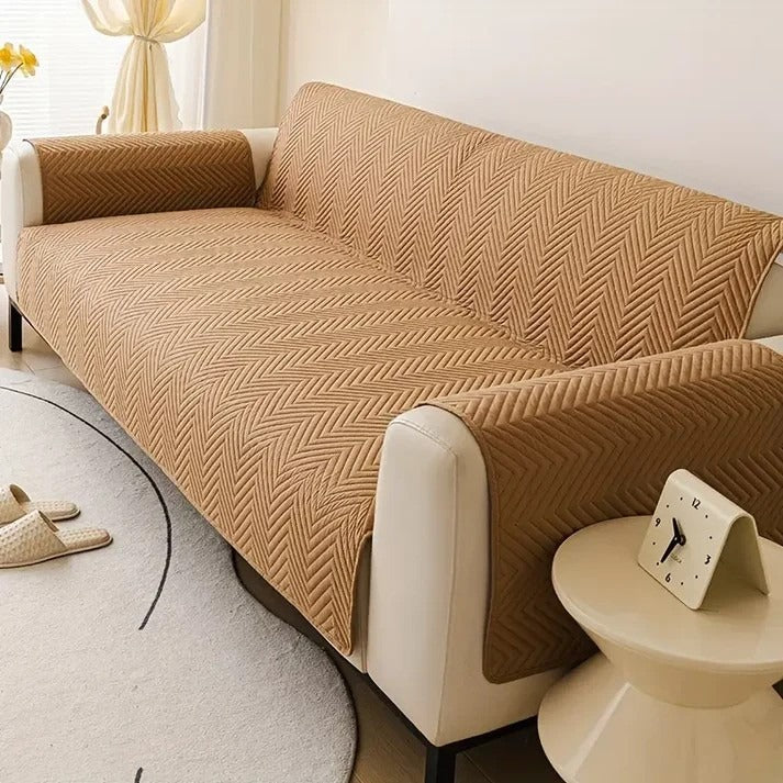 Beige sofa cover on a beige sofa in a living room setting.