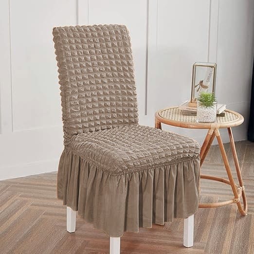 Chair with a brown textured cover in a room setting.