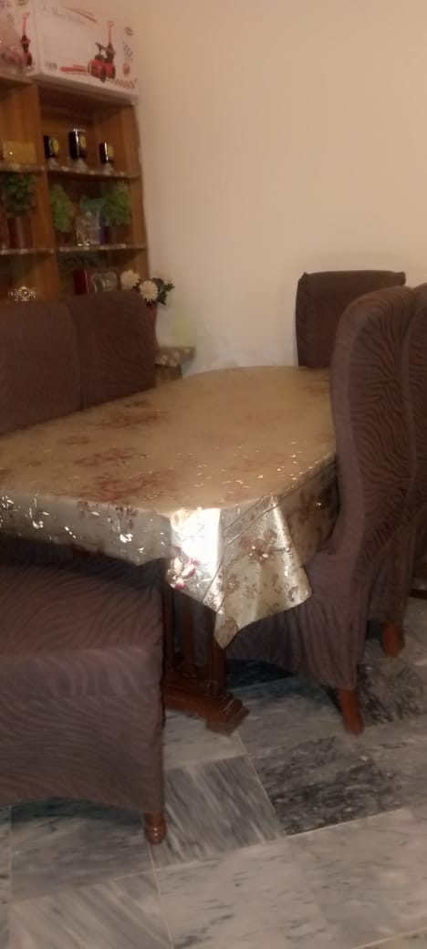 Dining area with a table and chairs in a room with a bookshelf.