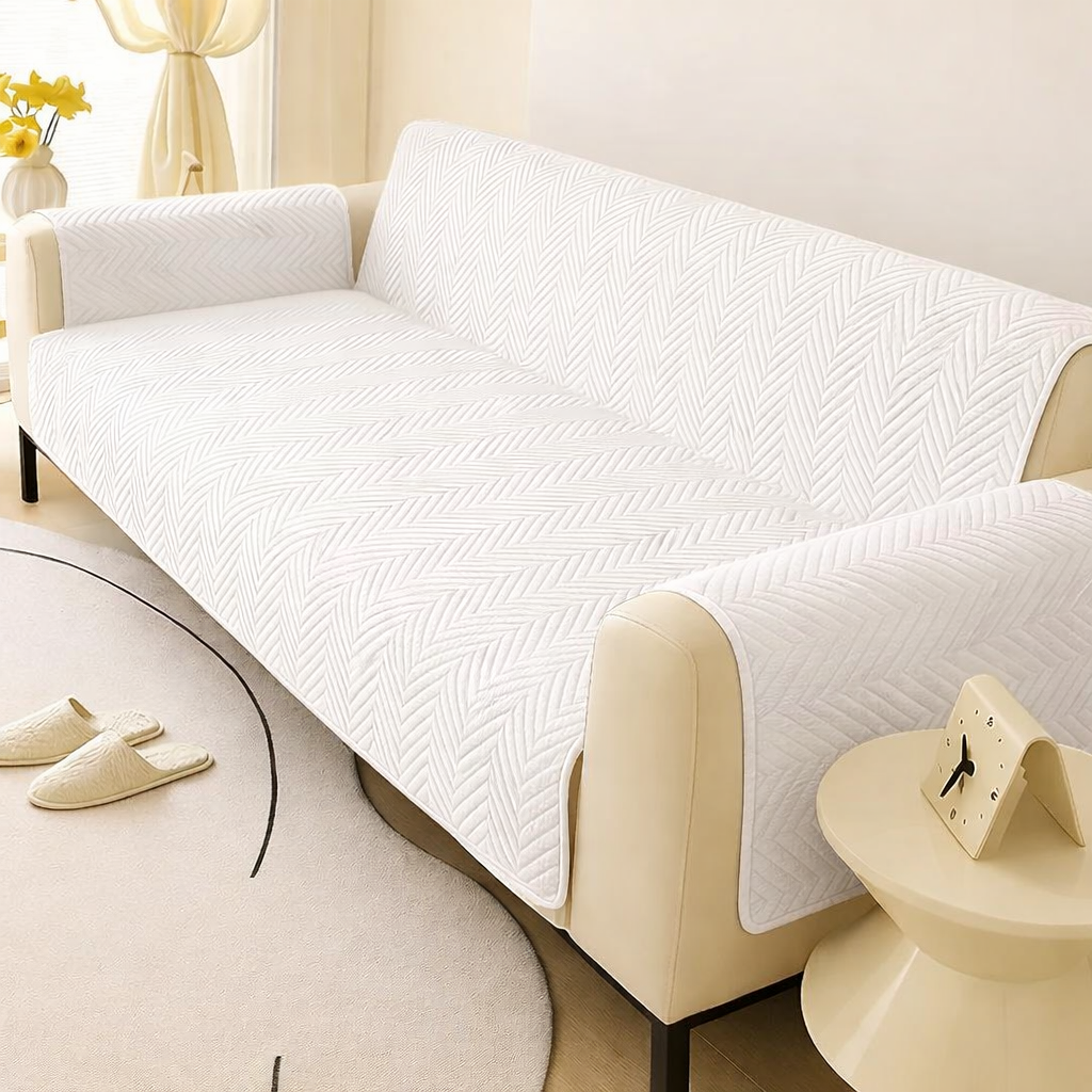 White textured sofa cover on a beige sofa in a living room setting.