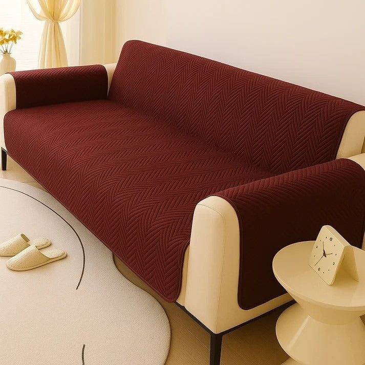 Reddish-brown sofa cover on a beige sofa in a living room setting.