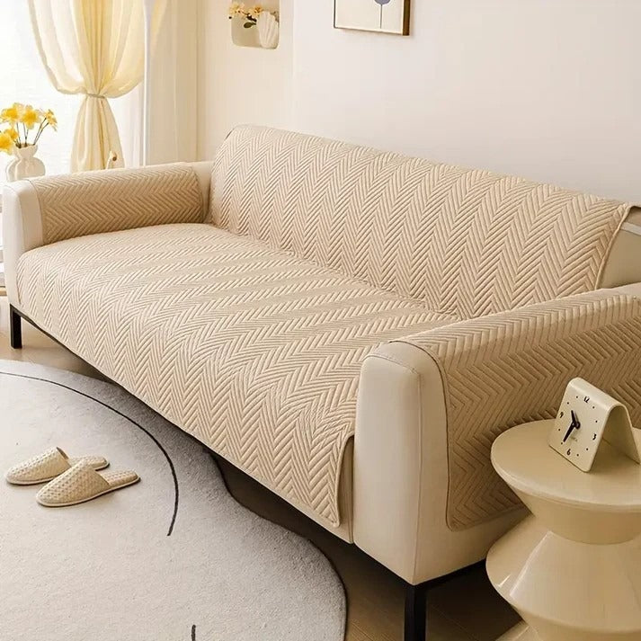 Beige sofa with a textured cover in a living room setting.
