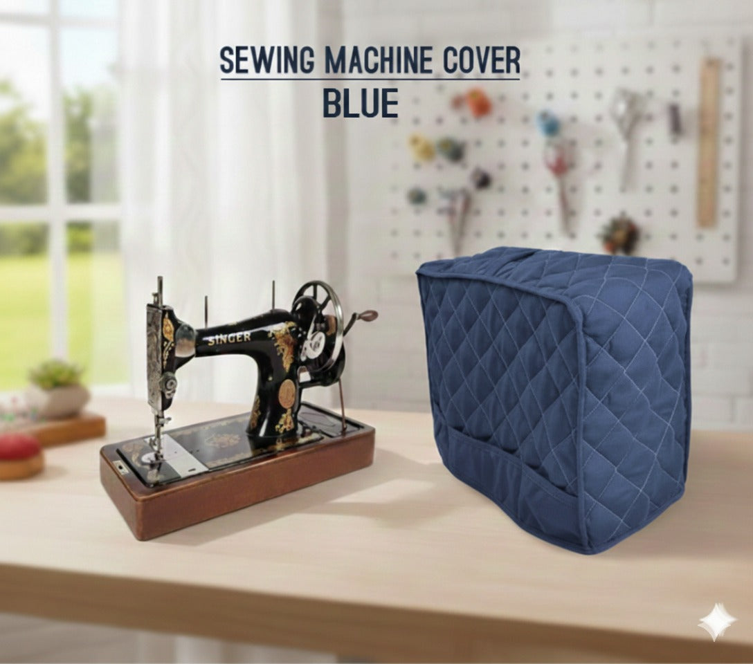 Blue sewing machine cover on a table with a vintage sewing machine in a workshop setting.