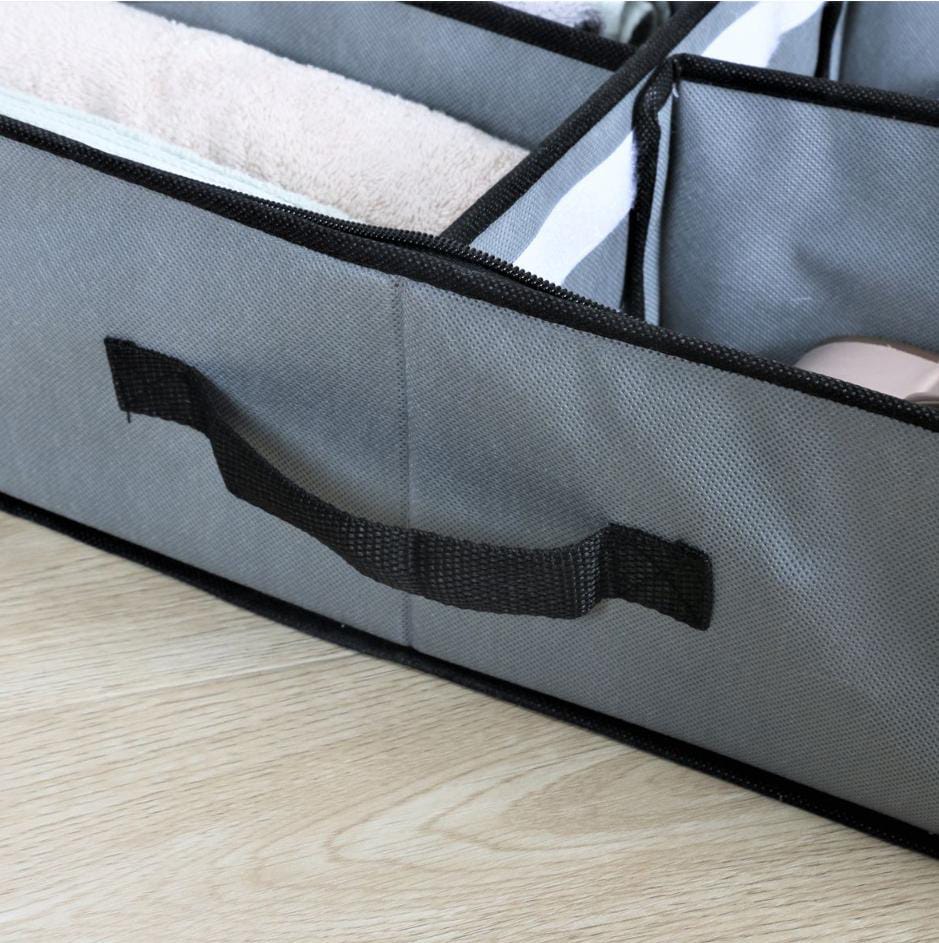 Gray storage bag with a black strap on a wooden surface