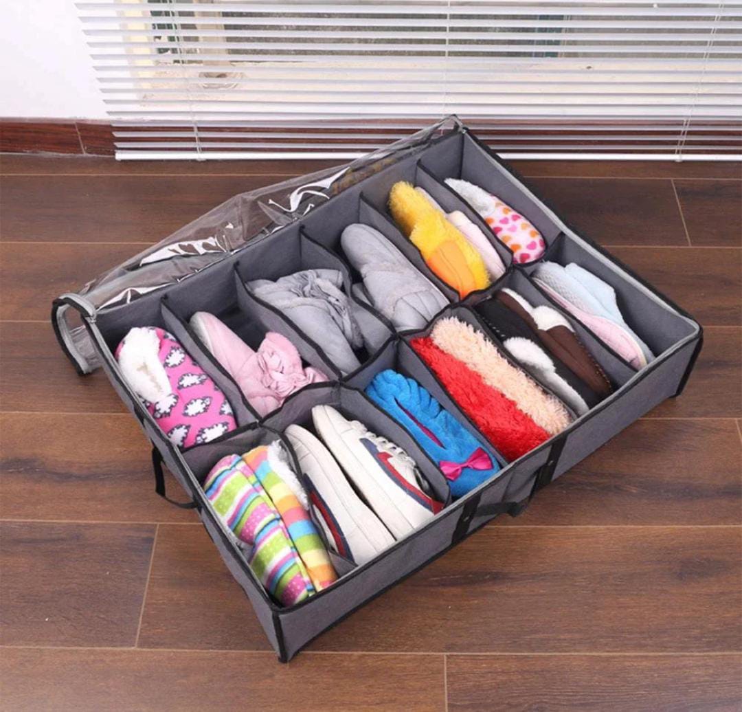 Gray storage organizer with compartments filled with colorful items on a wooden floor.