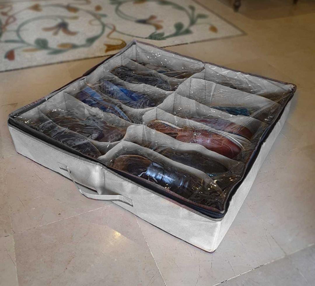 Storage box with compartments for shoes on a tiled floor