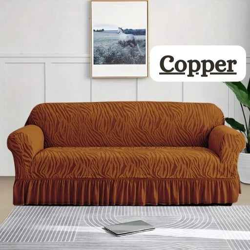 Brown patterned sofa cover on a couch with 'Copper' branding in the corner.