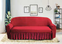 Red sofa cover on a red sofa in a living room setting with decor elements.
