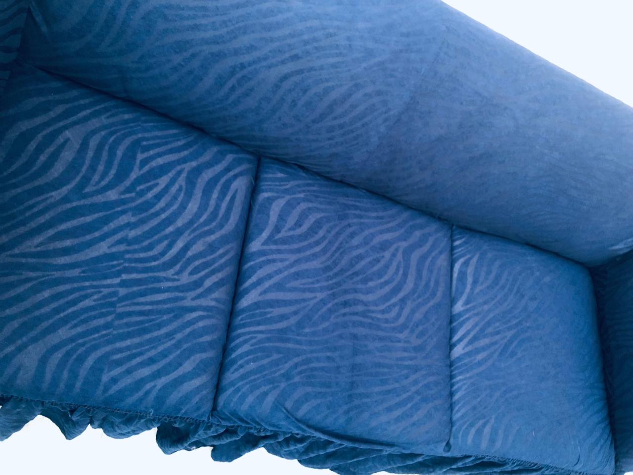 Blue textured fabric with wavy pattern on a white background