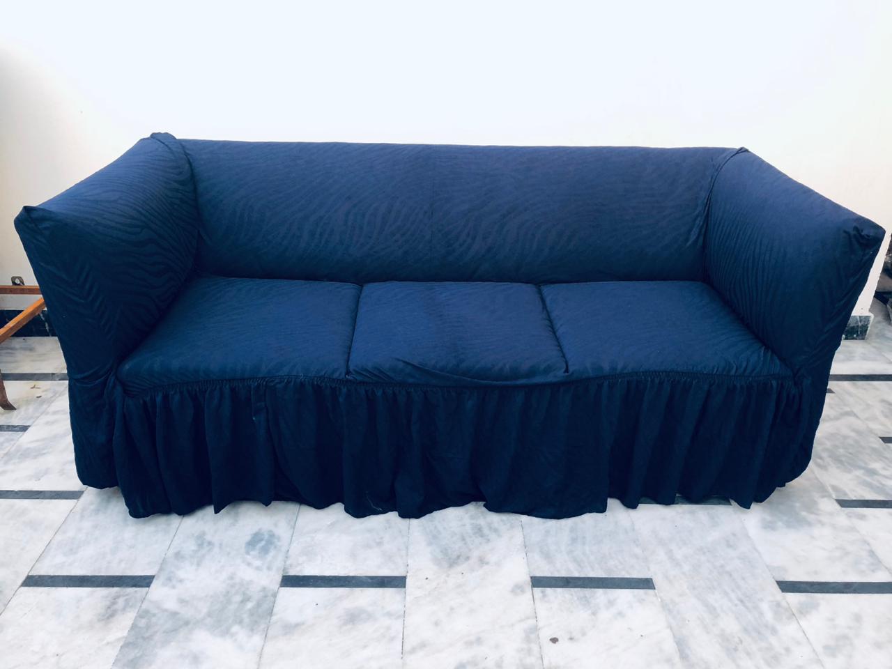 Navy blue sofa cover on a marble floor