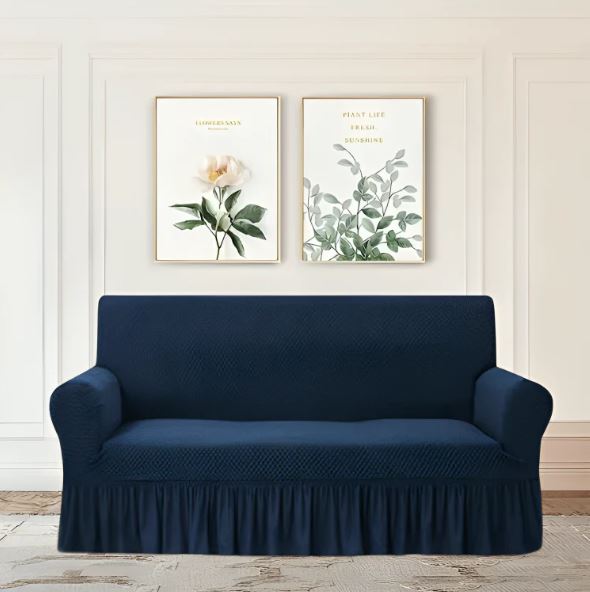 Navy blue sofa cover on a couch with floral wall art in the background