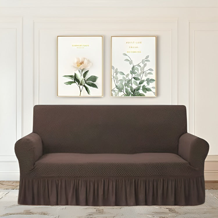 Brown sofa cover on a couch with floral wall art in the background