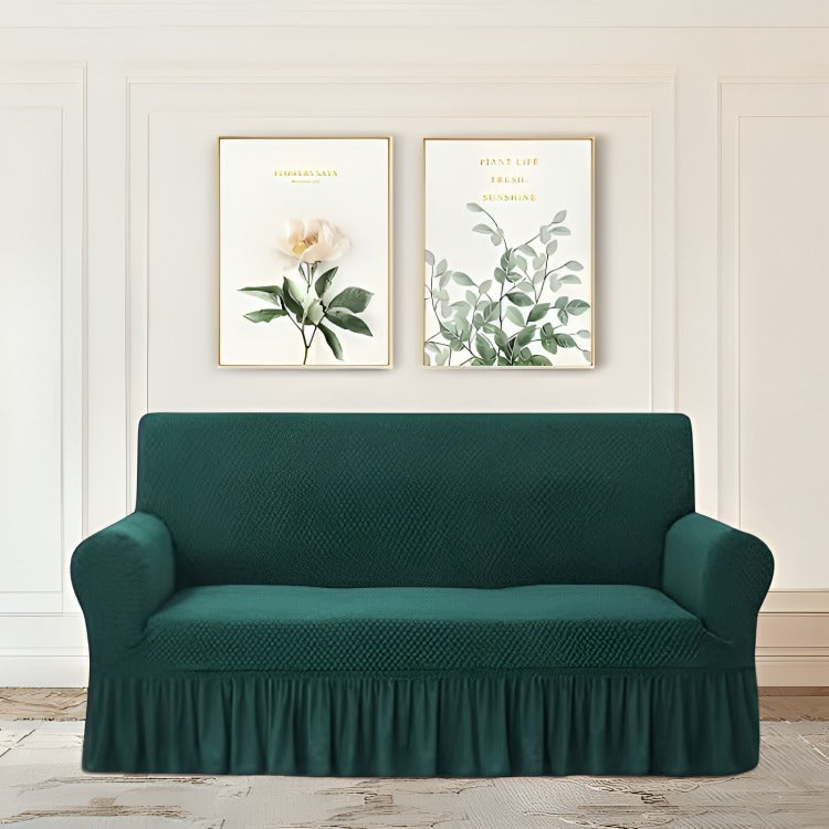 Green sofa cover on a couch with decorative wall art in the background