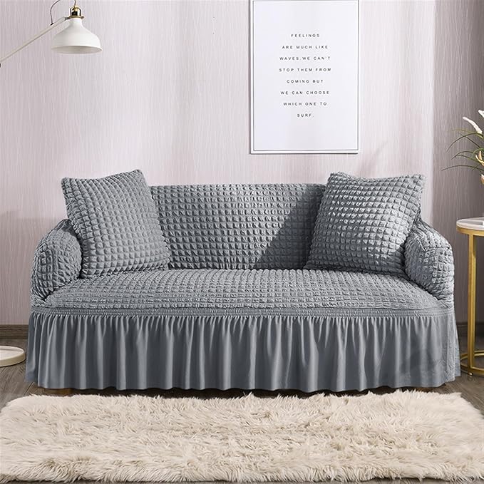 Gray textured sofa with matching cover in a living room setting.
