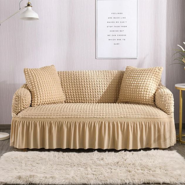 Beige sofa with a textured cover in a living room setting.