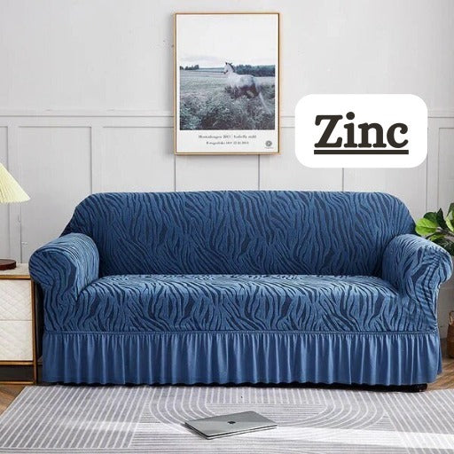 Blue sofa cover on a couch in a living room with 'Zinc' branding.