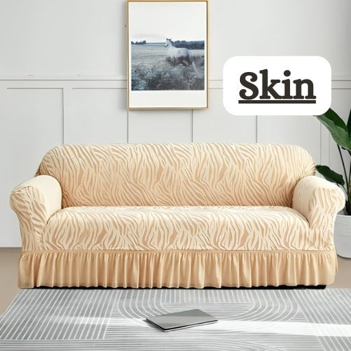 Beige sofa cover on a couch in a room with a painting and plant.