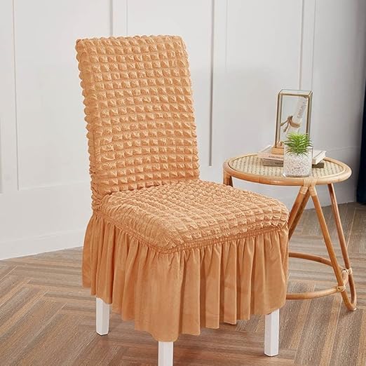Chair with a textured brown cover in a room with a small table and decor items.