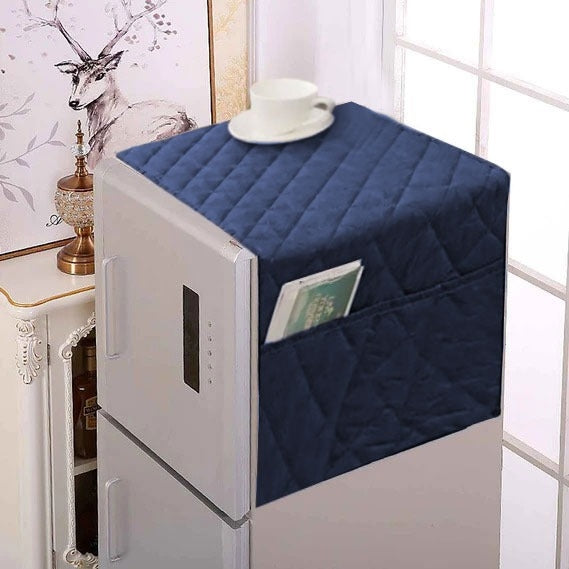 Navy quilted cover on a small refrigerator with a cup and plate on top, in a room setting.