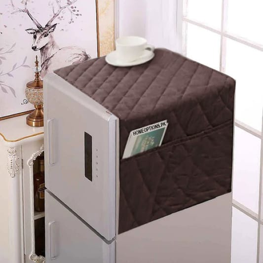 Brown quilted cover on a refrigerator with a decorative background