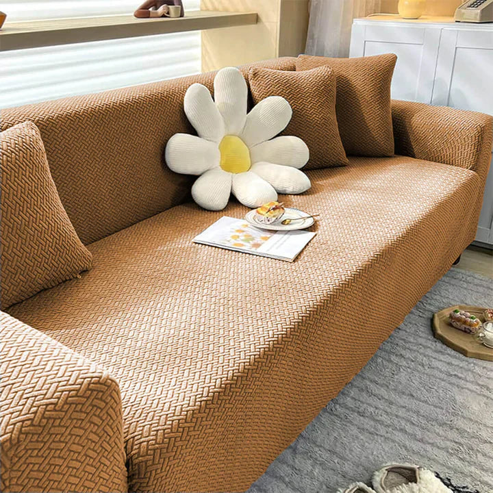Brown textured sofa with decorative pillows and a large flower-shaped pillow in a living room setting.