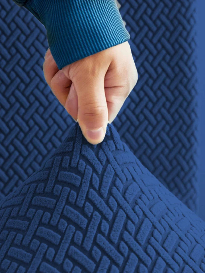 Hand pressing down on a textured blue mat with a person wearing a blue sleeve.